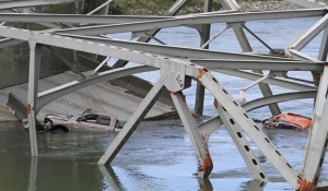 Cars are seen in the water as a span of highway bridge sits in the Skagit River May 24, 2013 after collapsing near the town of Mt Vernon, Washington late Thursday. REUTERS/Cliff DesPeaux